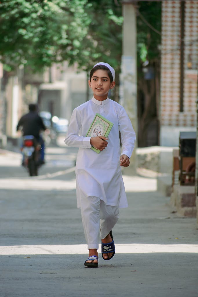 Boy in White Tobe carrying a Qran- quran with hindi translation full 1 to 30 pdf