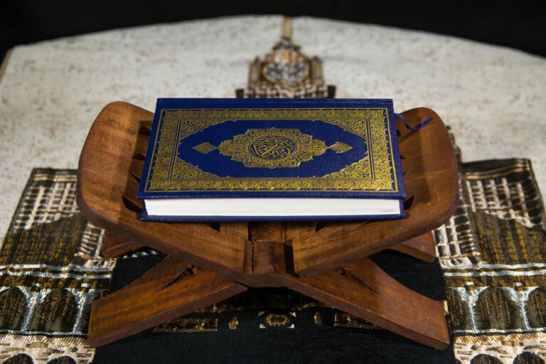 Close-up of the Quran on a wooden stand, symbolizing Islamic spirituality.